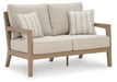 Hallow Creek Outdoor Loveseat with Cushion - Bill's Discount Center (Bradenton, FL)